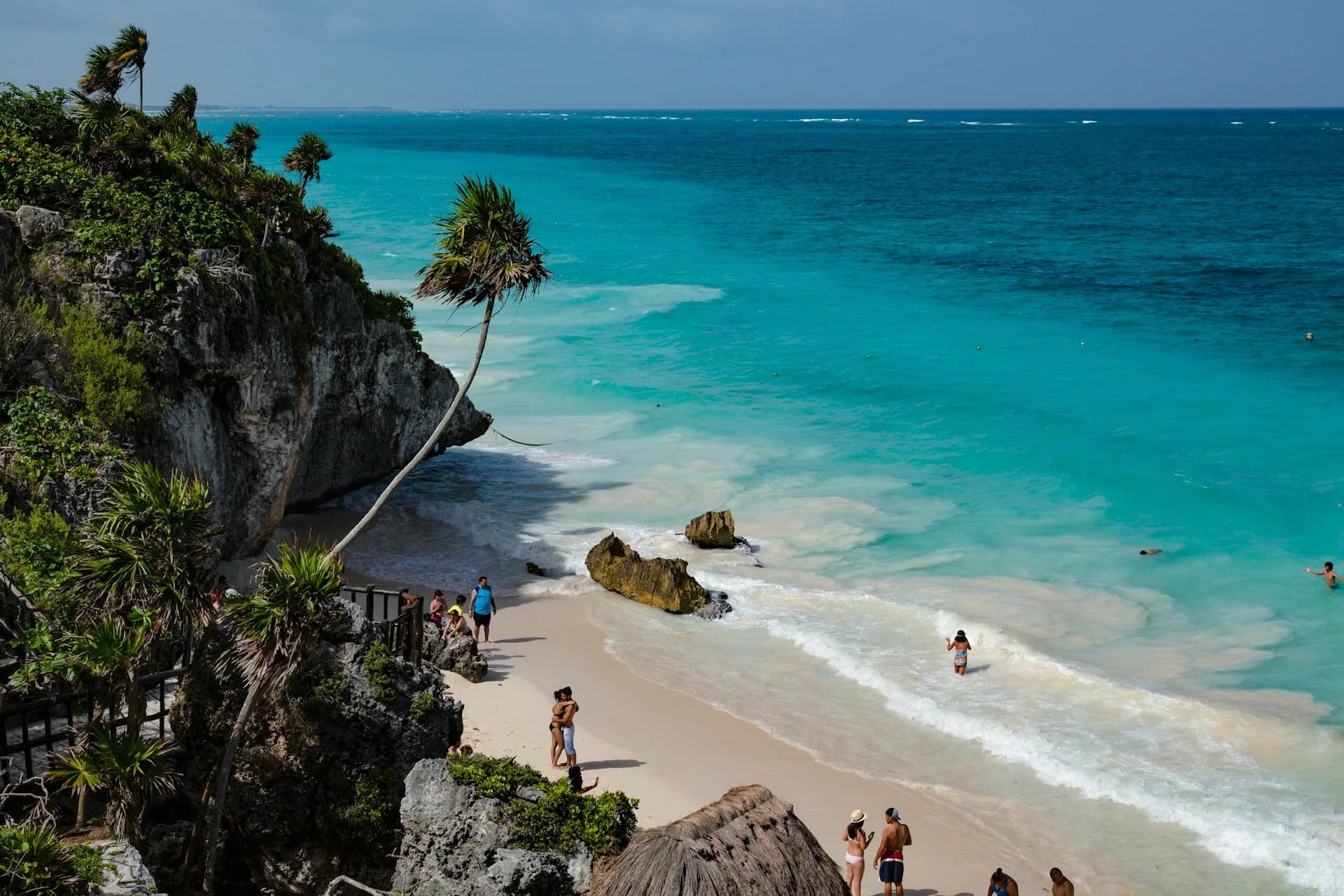 The Tulum ruins on a cliff above the turquoise Caribbean with a white-sand beach below, Quintana Roo, Mexico