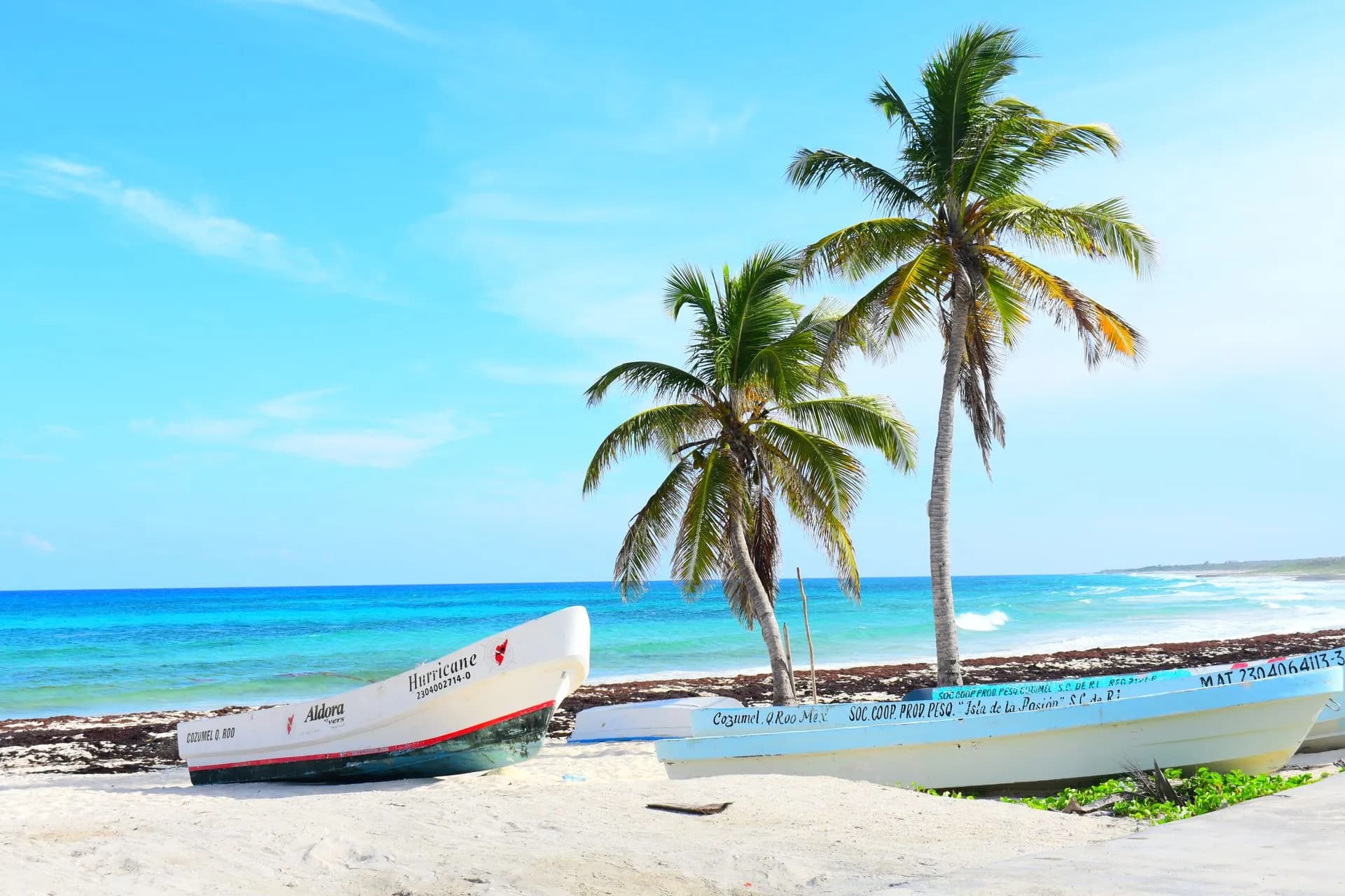 Warm calm water over a Cozumel reef with building afternoon clouds on a quiet May day