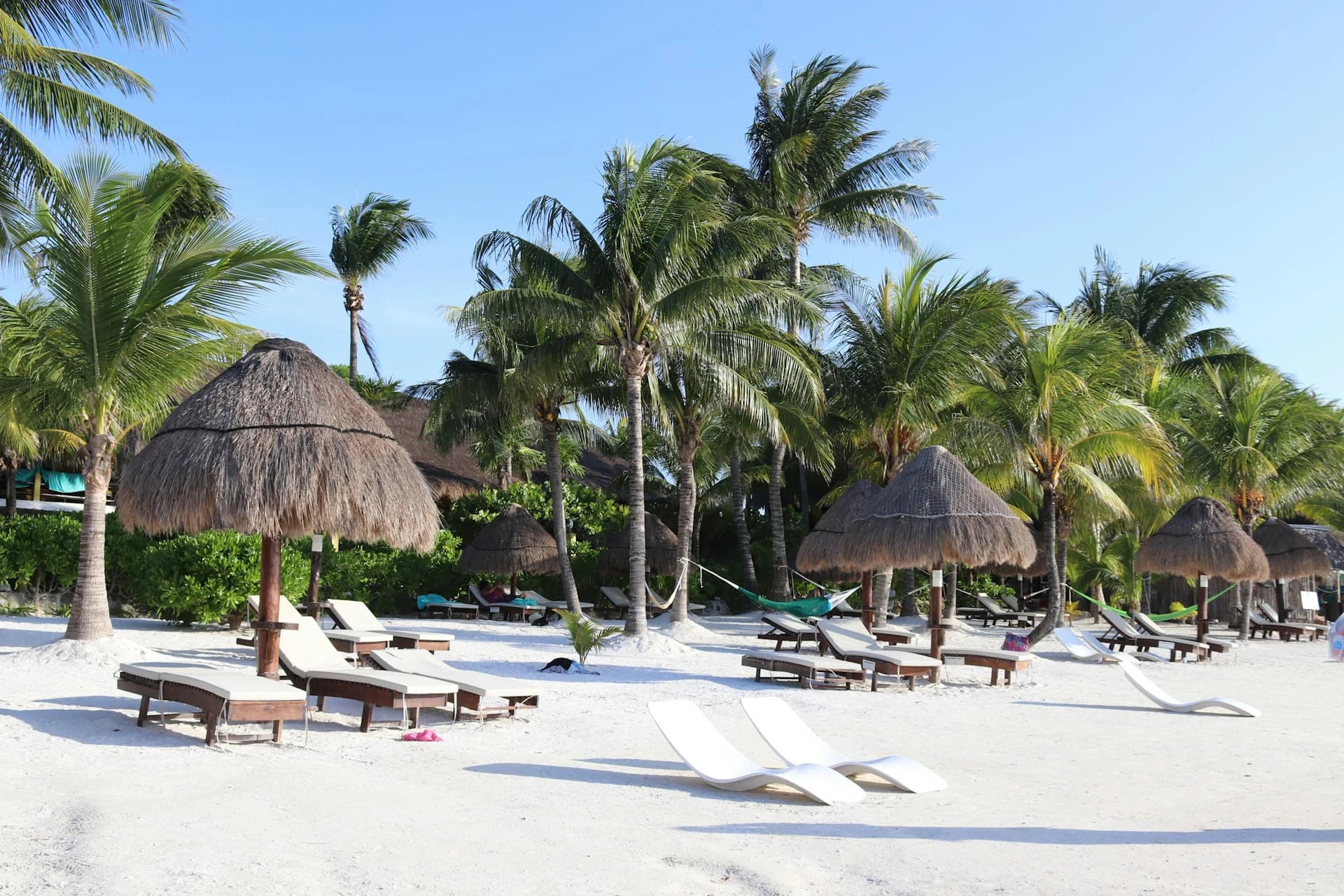Calm turquoise lagoon water and sandbar at Isla Holbox under a clear blue January dry-season sky
