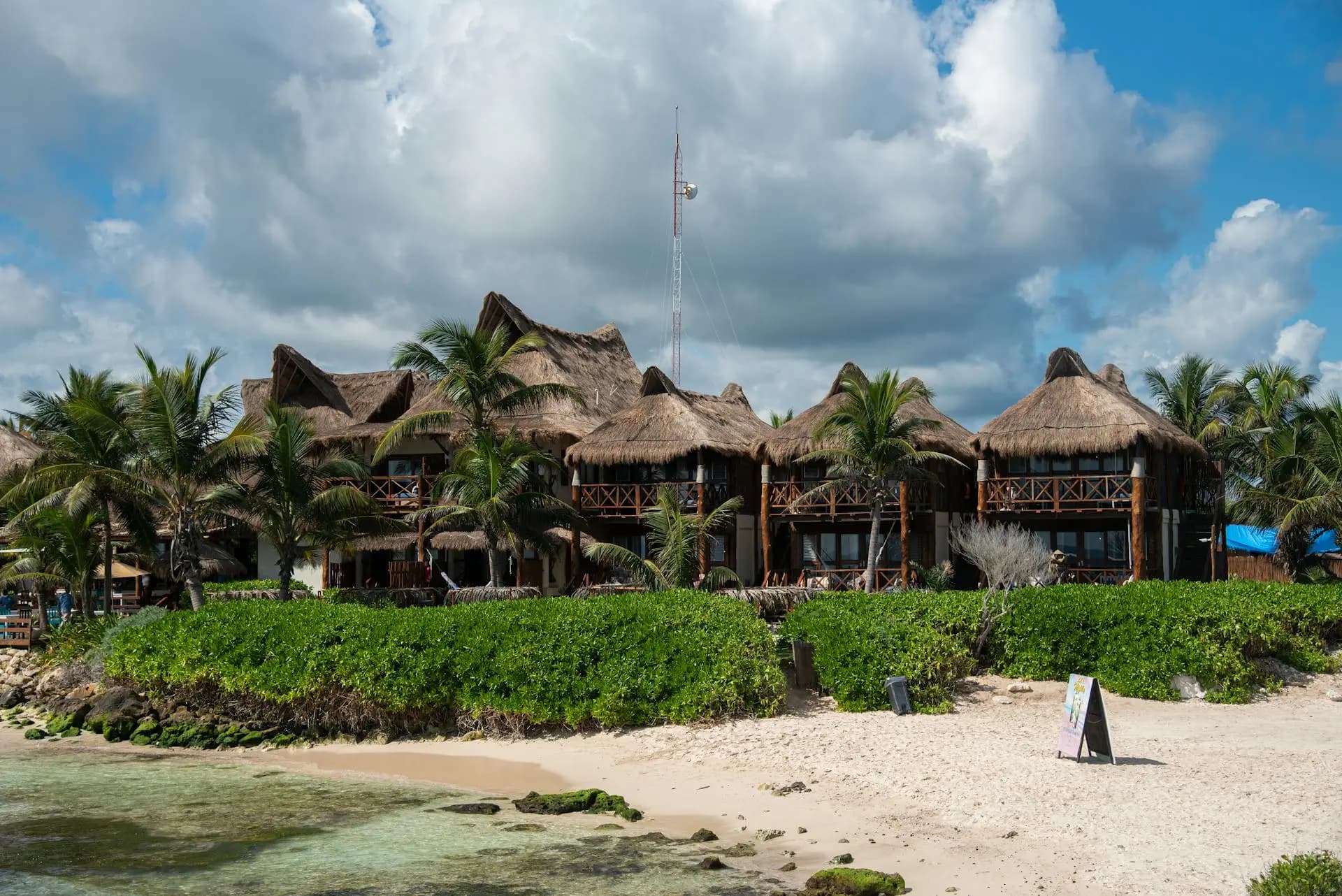 Playa Norte beach with calm turquoise water, white sand, and boutique hotel buildings on Isla Mujeres, Mexico