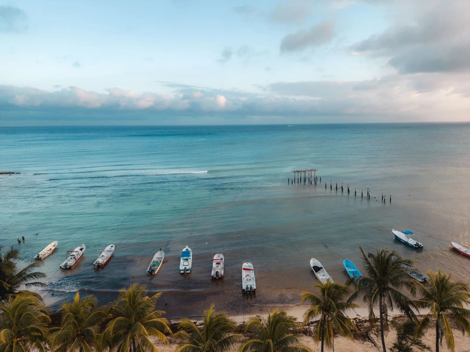 Clean white sand beach and clear turquoise Caribbean water in Playa del Carmen on a mild November day