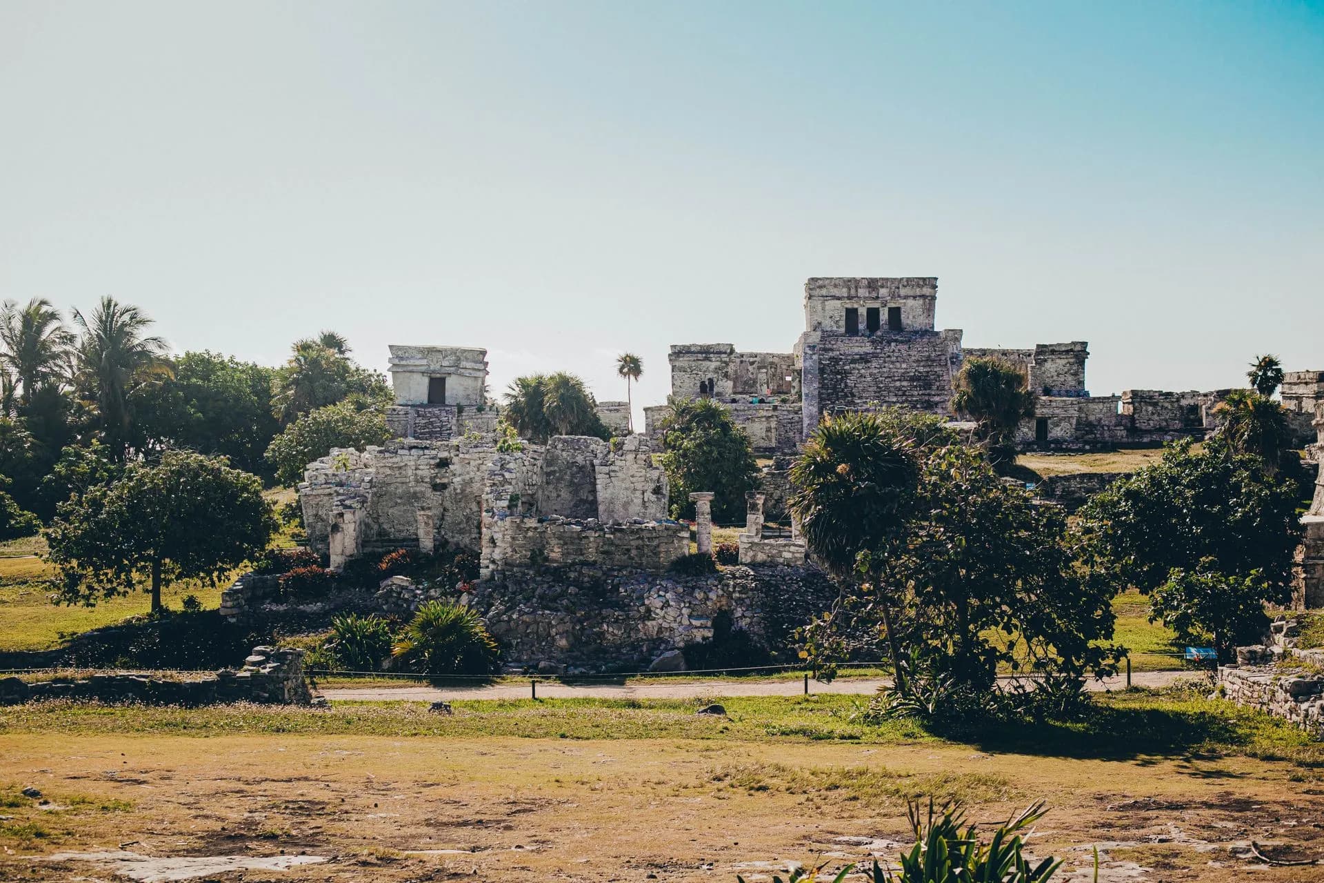 Moody turquoise Caribbean water below the Tulum ruins under dramatic September rainy-season clouds