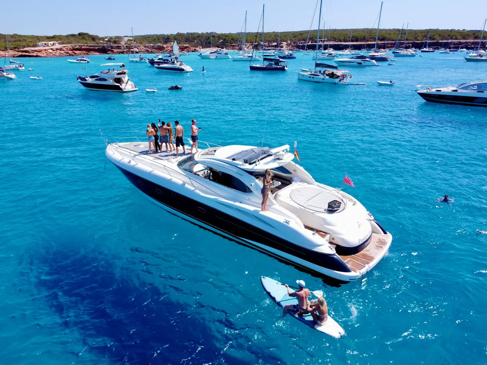 A private luxury yacht anchored in turquoise Caribbean waters off Cancún, Mexico