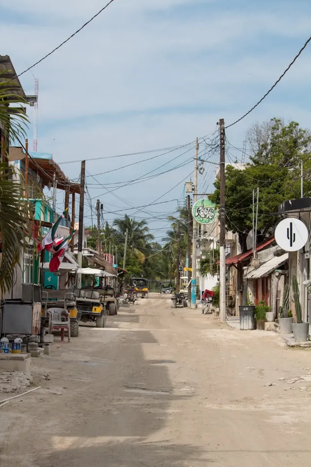Sandy streets in Holbox town center with golf carts, restaurants, shops, and small hotels