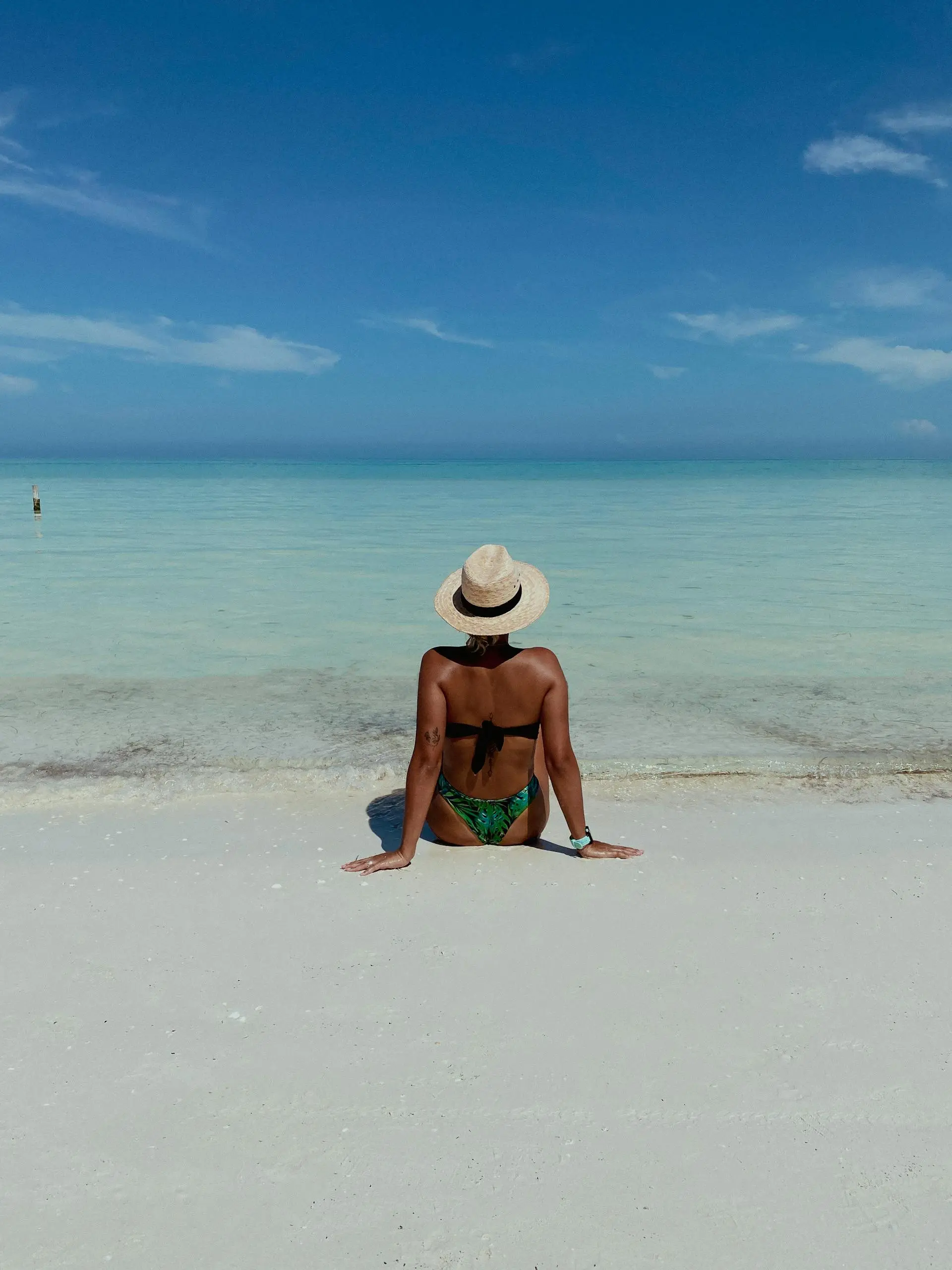Calm shallow turquoise water and white sand beach on Isla Holbox